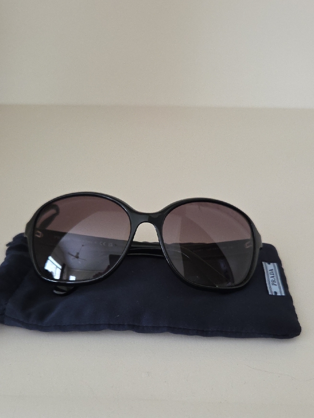 Prada Women’s Black Frame Sunglasses with Smoky Lenses